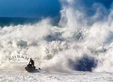 jet ski rider infront of a crashing wave
